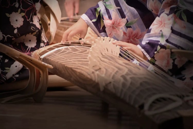 A woman performing on the Taishogoto