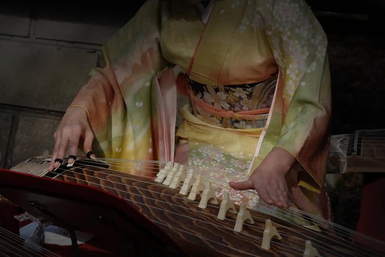A woman playing the koto