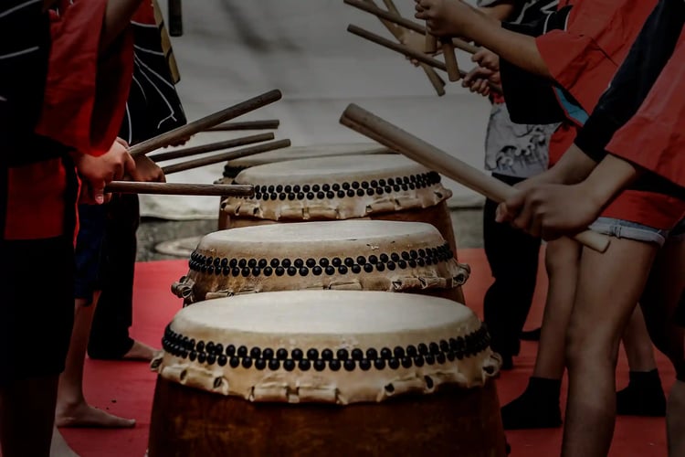 Image of young people playing taiko drums.