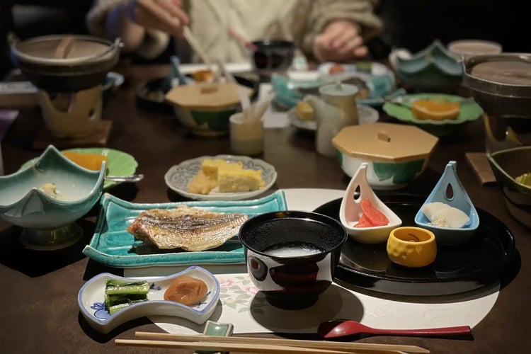 Enjoying a kaiseki meal together, seated facing each other