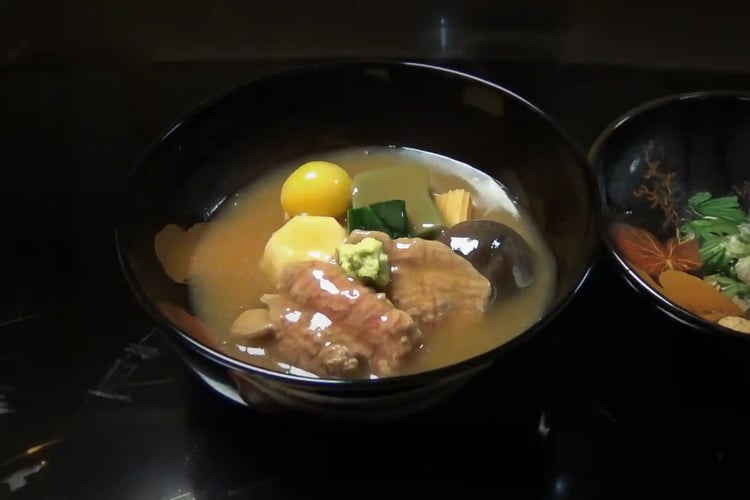 Enjoying Jibu-ni, a local specialty dish made with local ingredients, in the tranquil setting of a historic traditional Japanese house