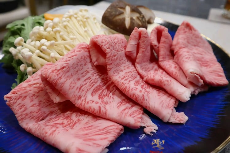 Delicious-looking sukiyaki beef and ingredients, featuring Kobe beef