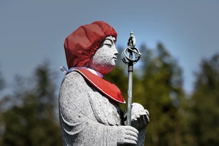 A common representation of Jizo Bodhisattva is holding a shakujo, a monk_s staff used to guide all living beings, in his right hand, and a hoju, a wish-fulfilling jewel, in his left hand