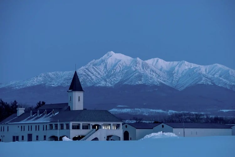 A building with a steeple and Mount Shari