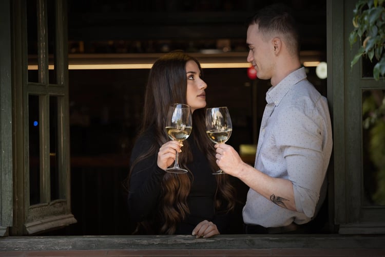 Six men and women enjoying wine