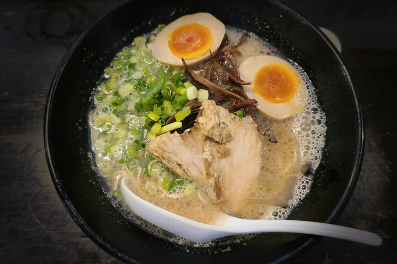 A bowl of Hakata tonkotsu ramen with thin straight noodles