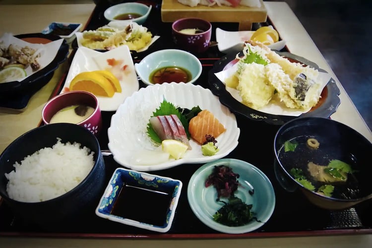 A vibrant and colorful Japanese meal of sashimi and tempura