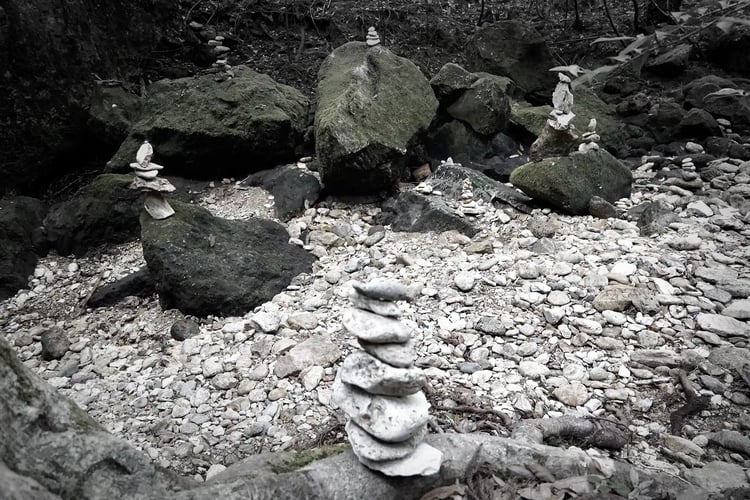 Meditation Experience Piled Stones in a Moss-Covered Forest