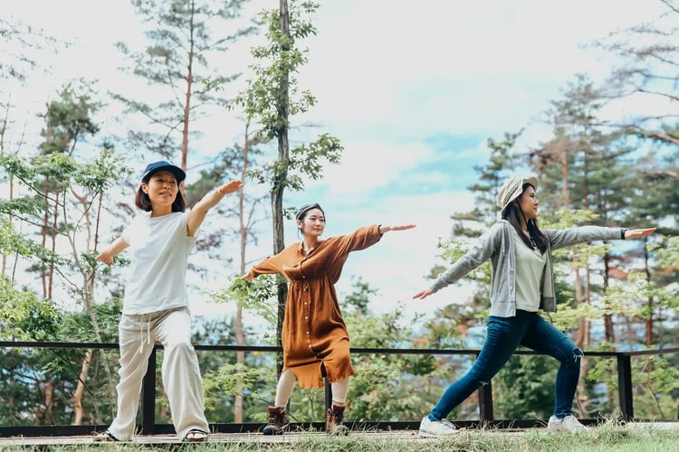 A woman doing yoga in the forest