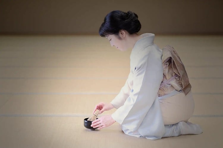 A middle-aged woman in a kimono hosting guests with the spirit of Wabi-Sabi