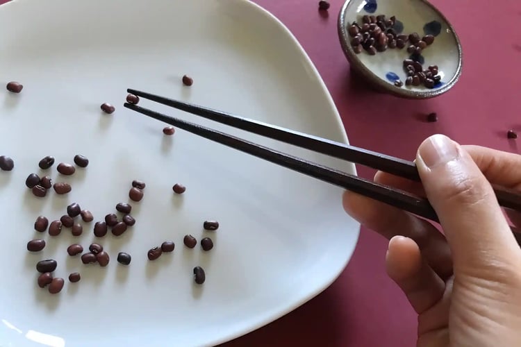practicing with chopsticks