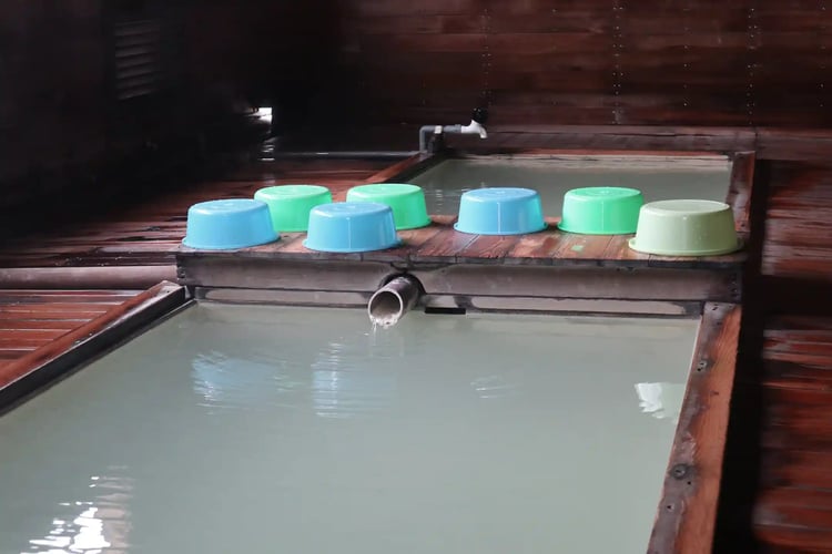 A secluded hot spring in the mountains with colorful tubs