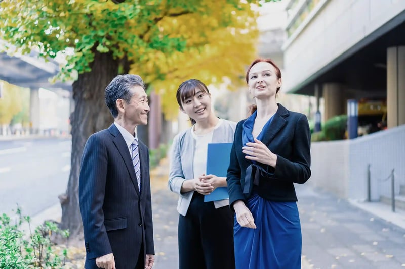 A man and a woman walking outside with an interpreter