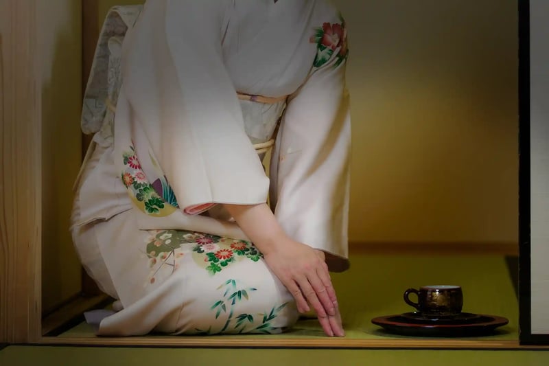 A woman in a kimono serving tea