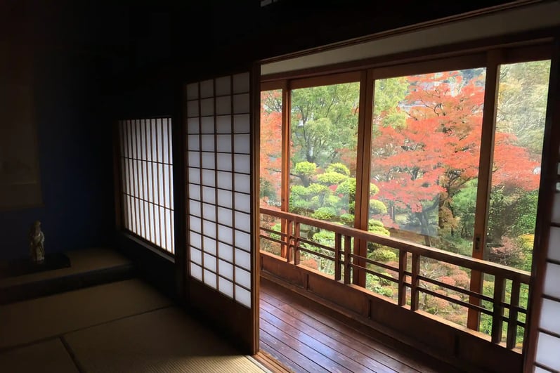 Japanese-style architecture and an autumn-leaf garden