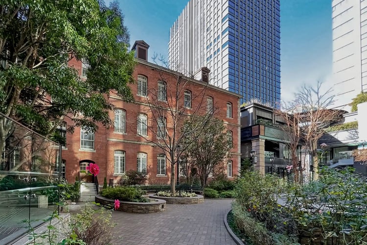 An urban museum where beautiful gardens and striking red bricks create a stunning contrast