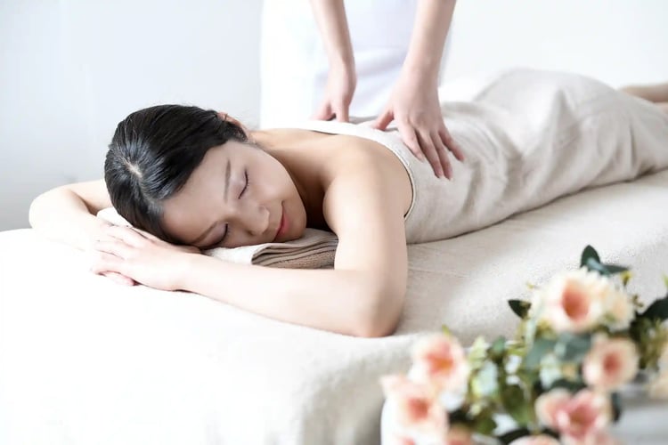 A young woman receiving a beauty treatment on a massage bed