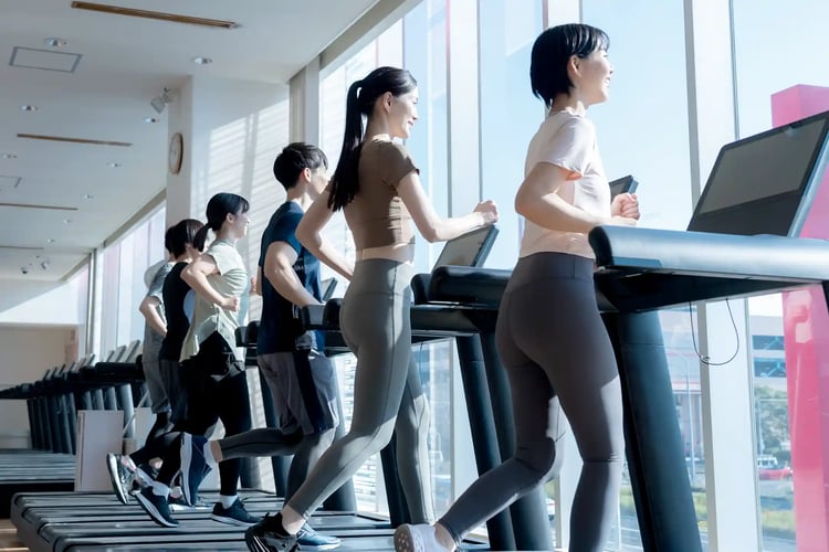 Young men and women working out at a gym