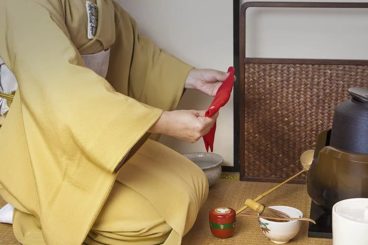 The etiquette of the tea ceremony involves welcoming guests while sitting in the seiza (formal kneeling) position