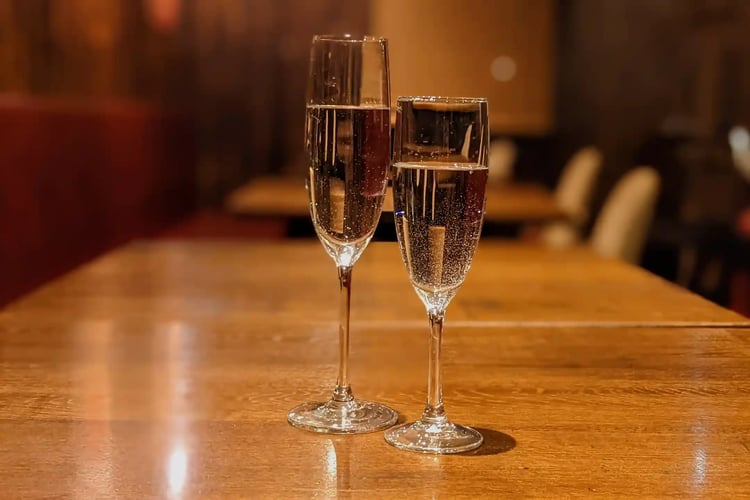 A Pour of Champagne in a Champagne Glass
