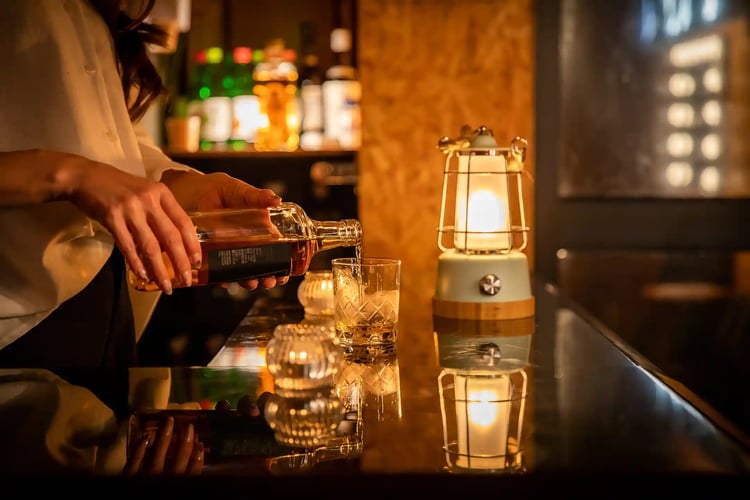 Bartender Serving Drinks at a Bar Counter
