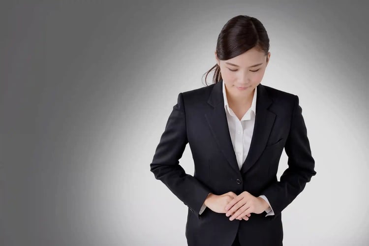 A young Japanese businesswoman bowing to someone