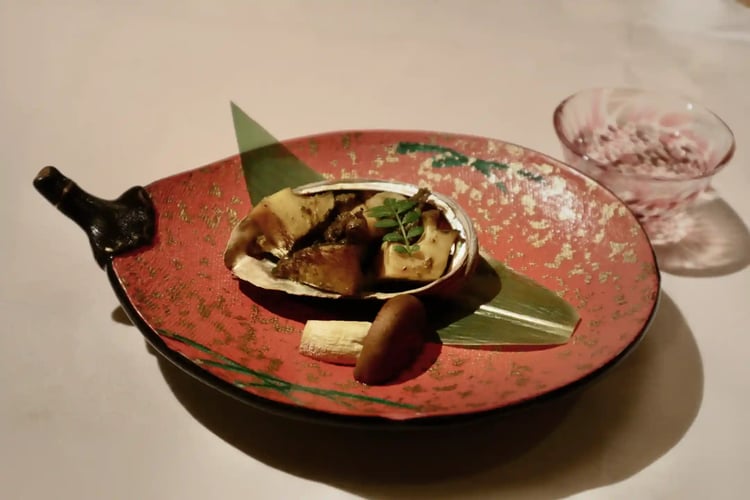 Abalone liver grilled and presented in vibrant dishes