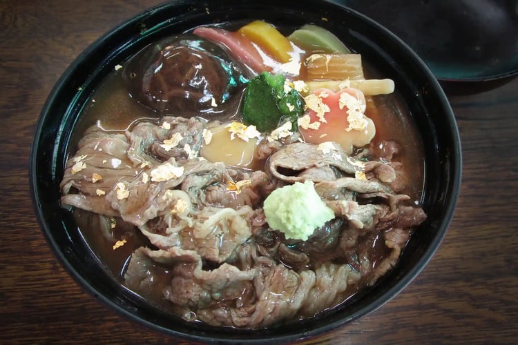 Jibuni stew topped with edible gold leaf