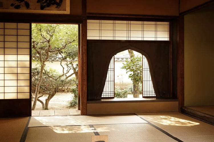 A sunlit Japanese-style room with a Kato-mado (bell-shaped window)