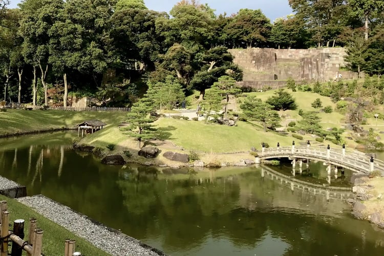 A Japanese garden with a flowing stream