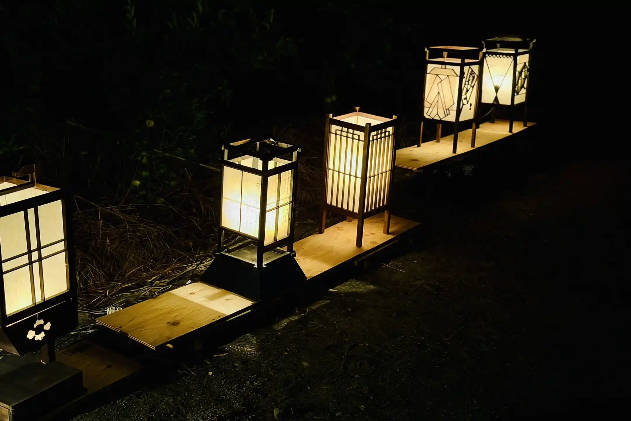 The gentle glow of lanterns illuminating the night path