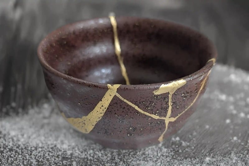 A Traditional Japanese Tea Bowl Repaired with Kintsugi Gold Joinery