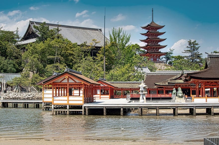 Itsukushima Shrine and the five-storey pagoda seen from the water by day