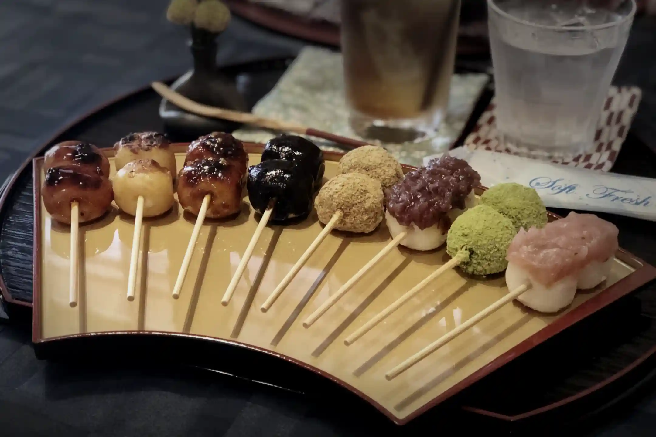 A platter of dango showing different toppings and glazes