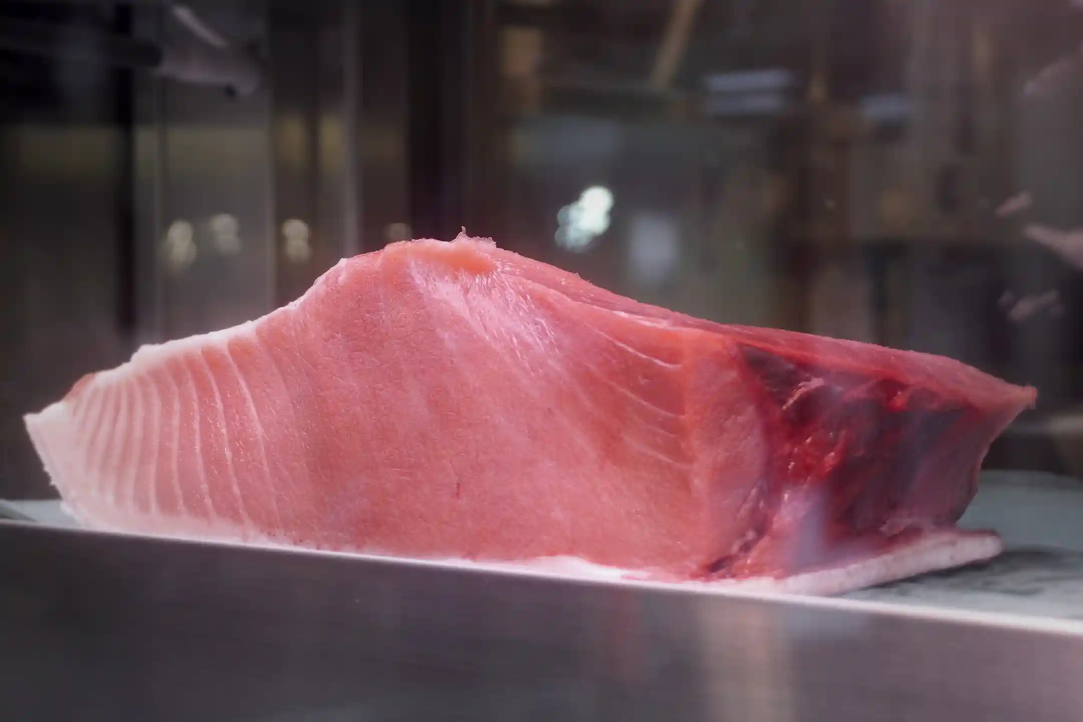 A block of fatty tuna on display at a Kuromon Ichiba Market fish counter