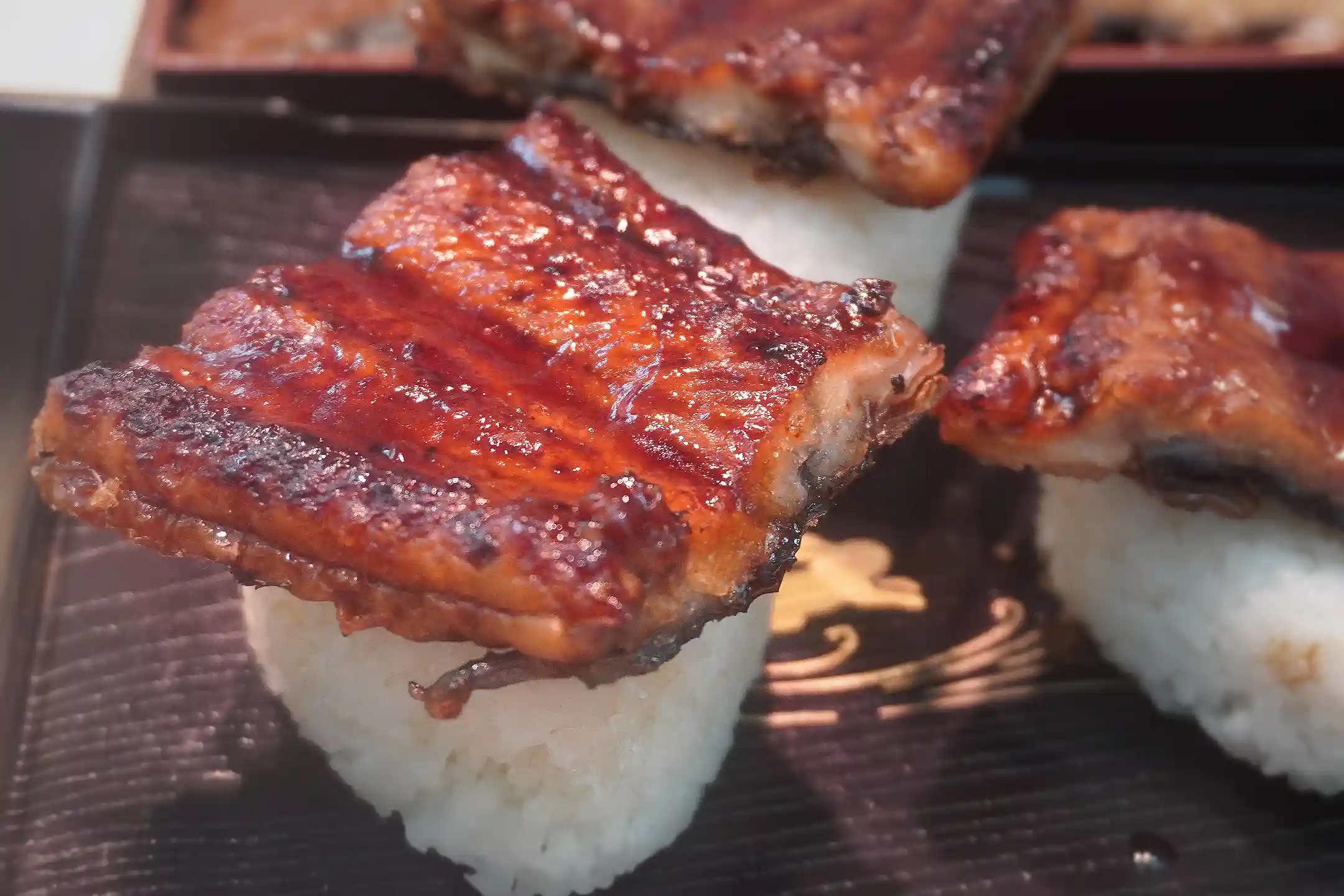 A grilled eel rice ball prepared at a Kuromon Ichiba Market counter