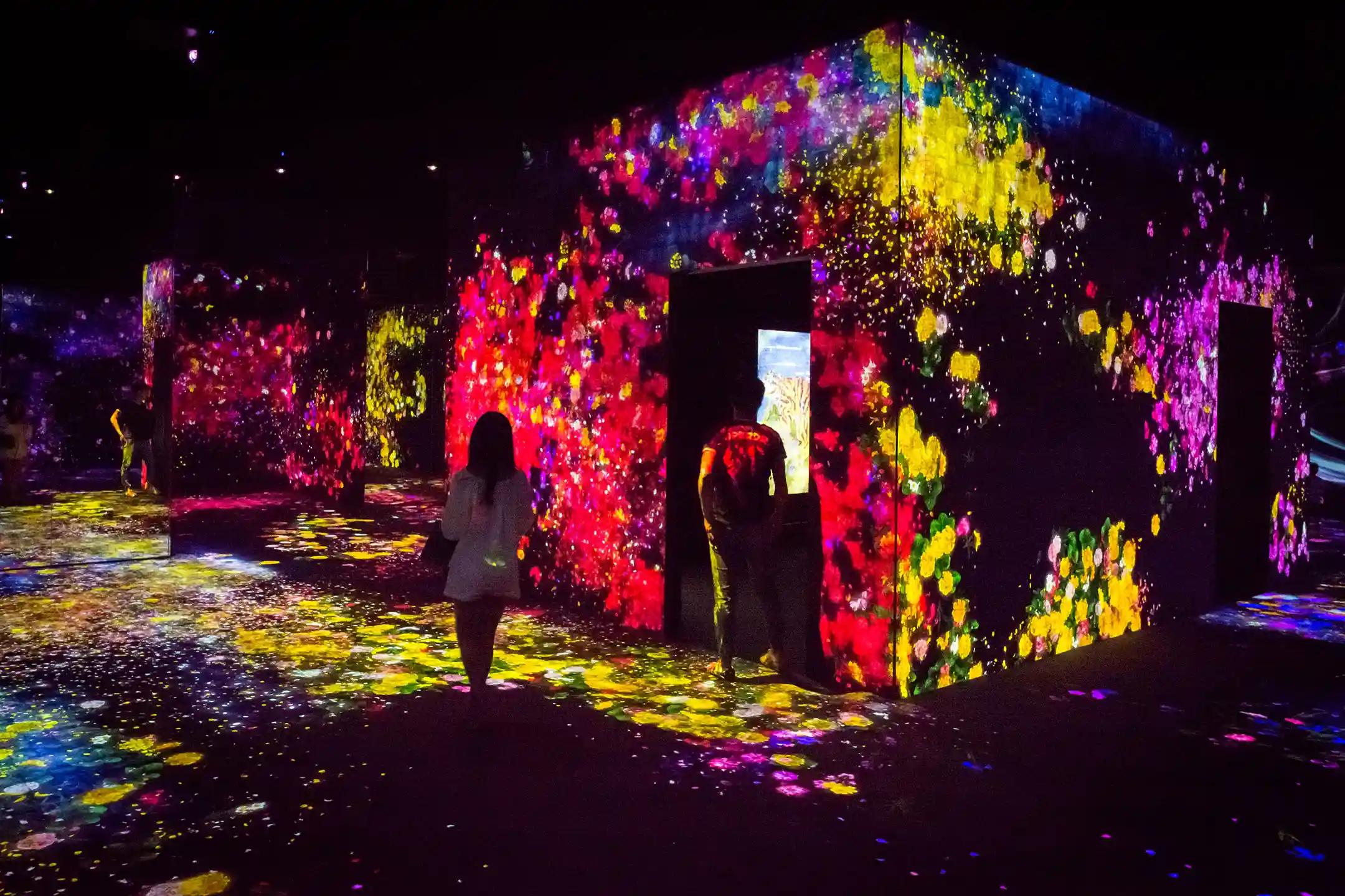 Visitors in a corridor of projected light at teamLab Borderless in Odaiba, the museum's original home, which closed in 2022