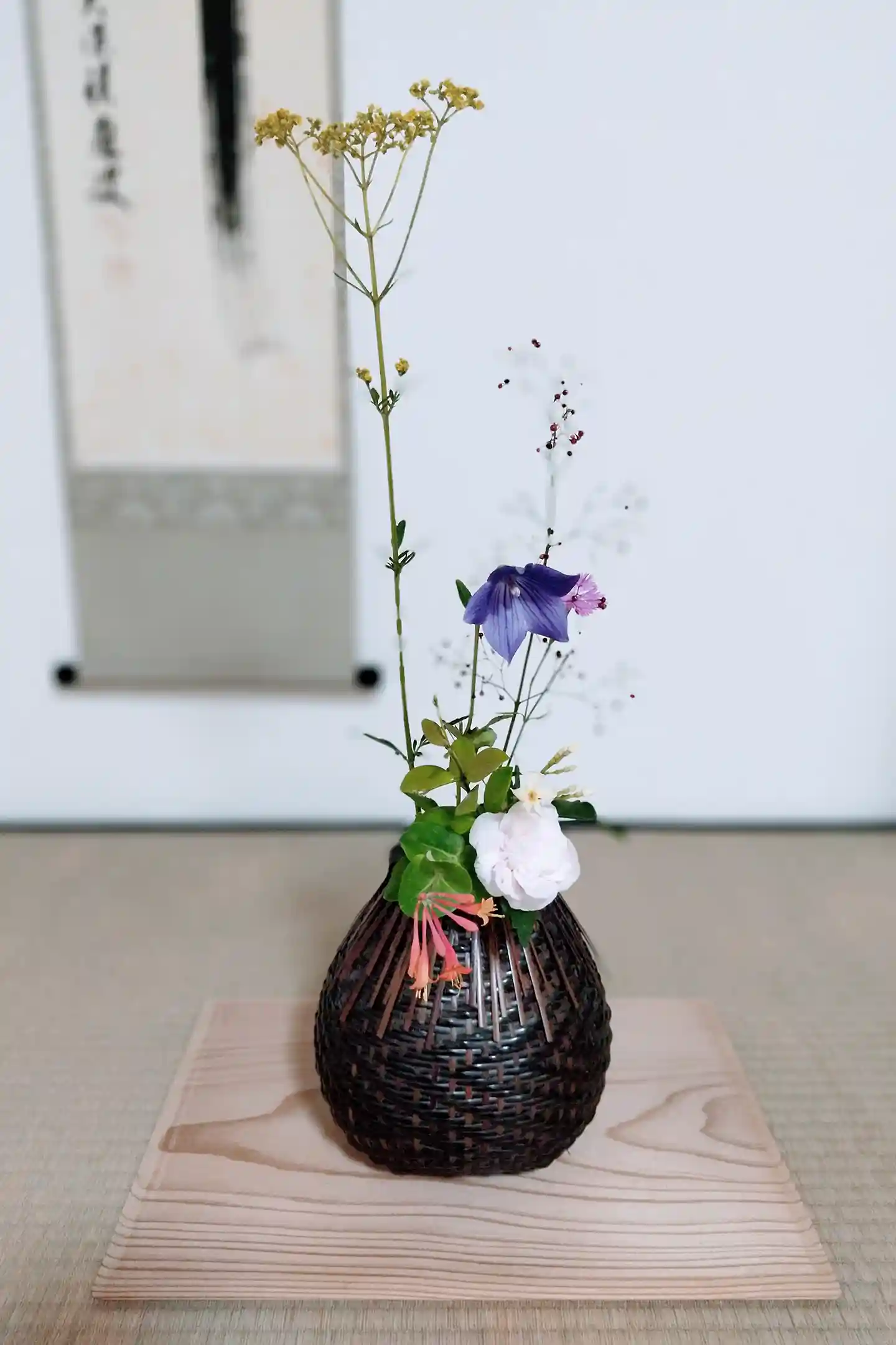 A Traditional Tokonoma Alcove Arranged with a Hanging Scroll, Flowers, and a Hearth