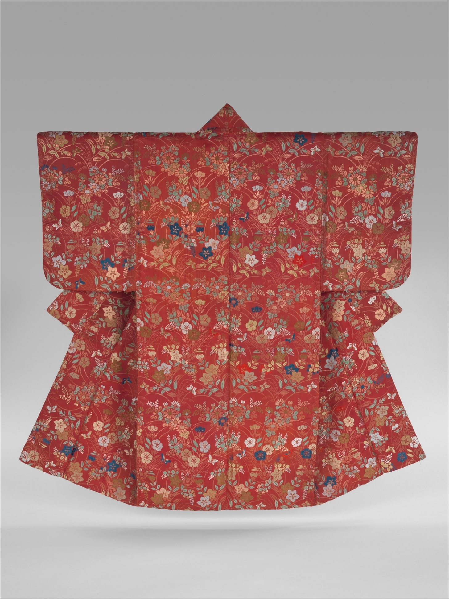 An early nineteenth-century noh robe in the Metropolitan Museum of Art, deep red twill-weave silk brocaded all over with autumn grasses, flowers and butterflies