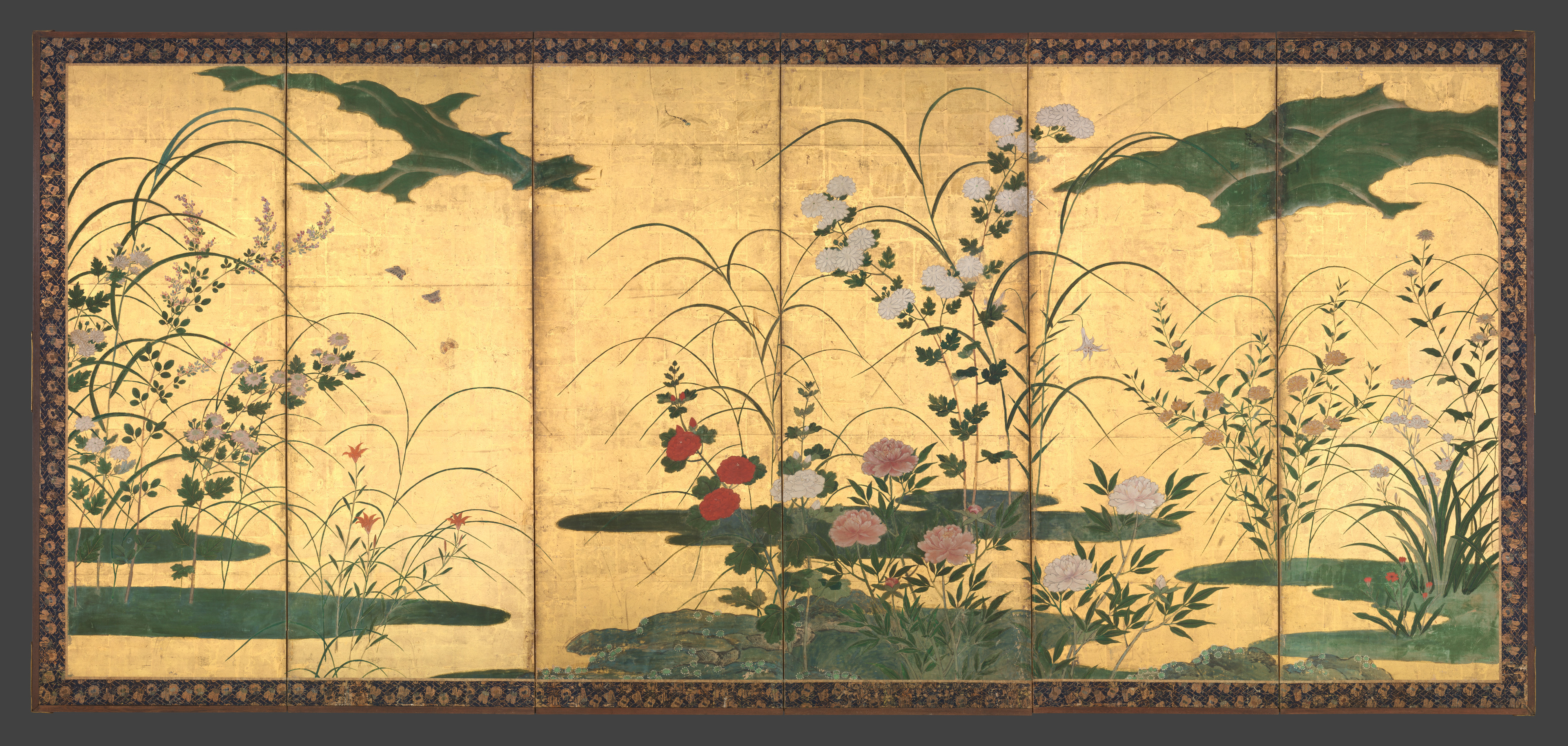 A late sixteenth-century six-panel folding screen by Kano Mitsunobu in the Metropolitan Museum of Art: red and pink peonies at the centre, pale bell-shaped blooms and tall grasses along low green banks on a gold ground, with green cloud bands across the top