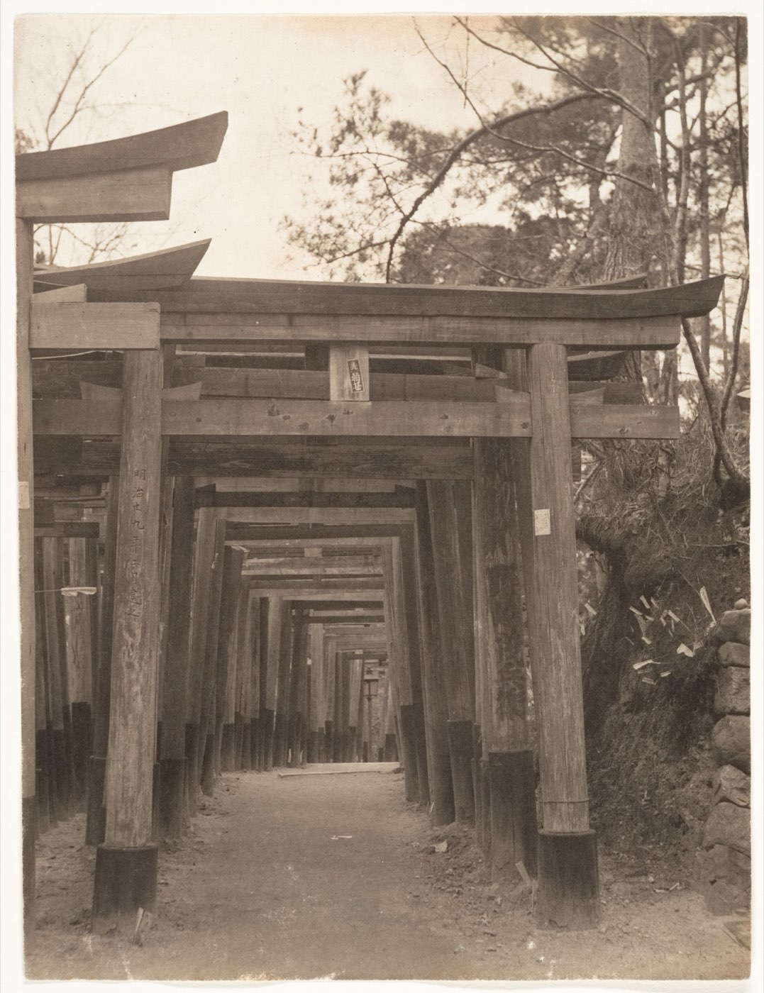 A 1900 photograph by Adolf de Meyer looking along a corridor of torii gates at Fushimi Inari Taisha