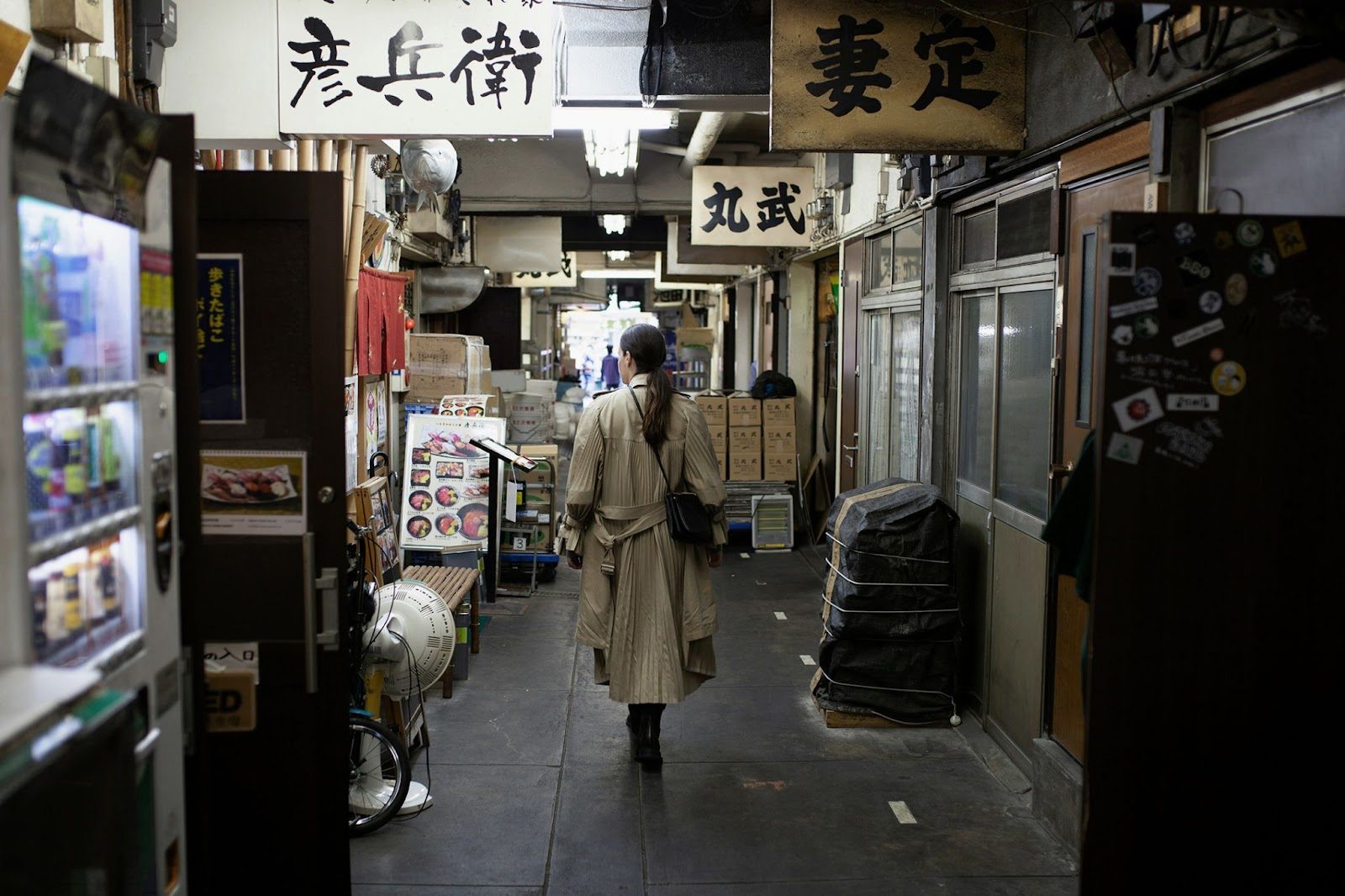 Early morning at Tsukiji Outer Market with shutters opening along a narrow lane
