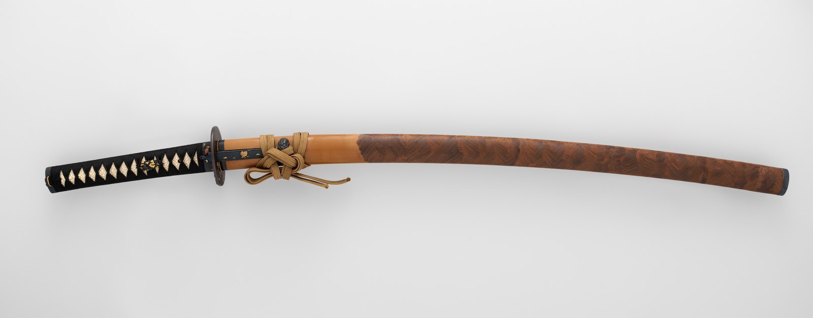 A matched long and short sword lying in their mountings, the pair a samurai carried