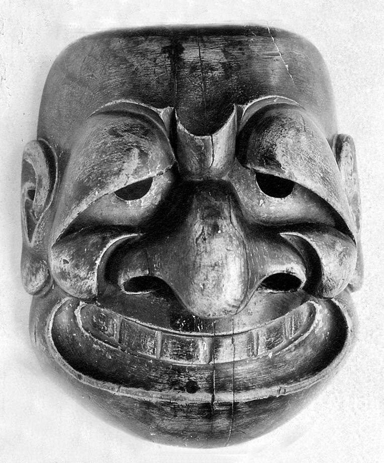 An eighteenth-century noh mask with a heavy brow and open mouth, carved for a role far from the young-woman masks